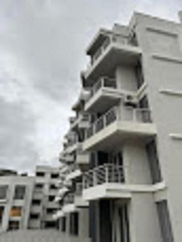 a tall building with balconies on the side of it at Ivy Bliss Studio with Private Pool, B 06, Karjat in Karjat