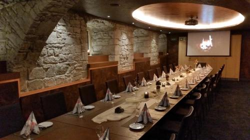 a dining room with a long table and chairs at City Partner Hotel Strauss in Würzburg