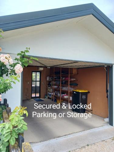 a garage with the words secured and locked parking or storage at Doonside Private Cottage at Grossi Point Reserve in Mapua