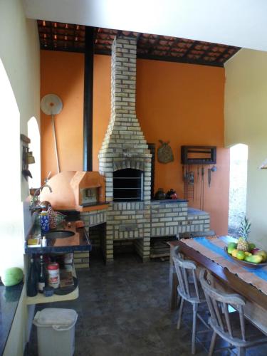 a living room with a fireplace in a house at Casa Litoral Sul - Praia Bela/ PB in Pitimbu