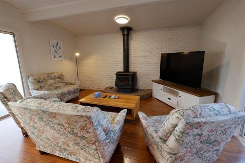 a living room with two chairs and a flat screen tv at home in capelsound in Capel Sound