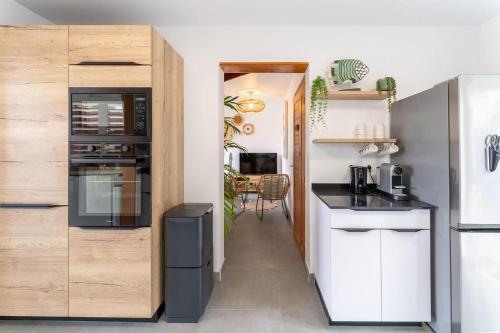 a kitchen with a refrigerator and a counter top at Villa Opale in Terre-de-Haut