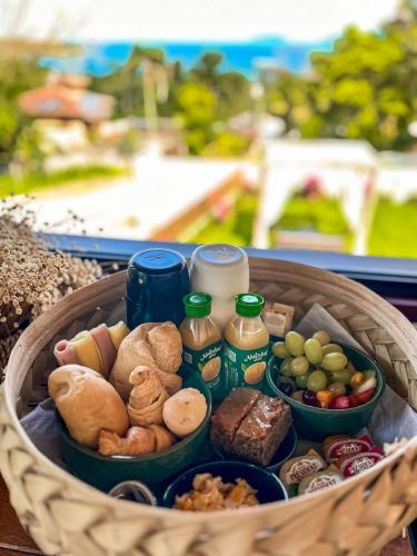 a basket filled with different types of food at Santomar Guest House in Ilhabela