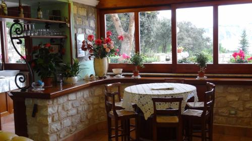 a kitchen with a table and chairs and windows at Hotel Internazionale in Ancona