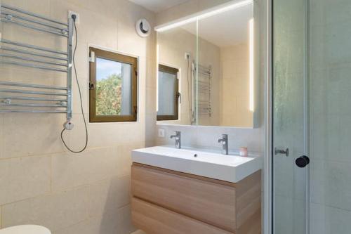 a bathroom with a sink and a shower and a mirror at Exclusive Villa Marbella in Marbella