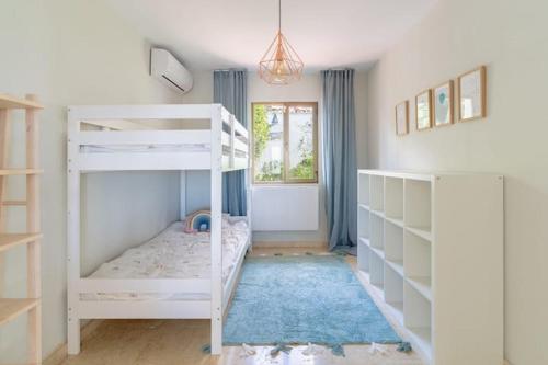 a bedroom with two bunk beds and a window at Exclusive Villa Marbella in Marbella