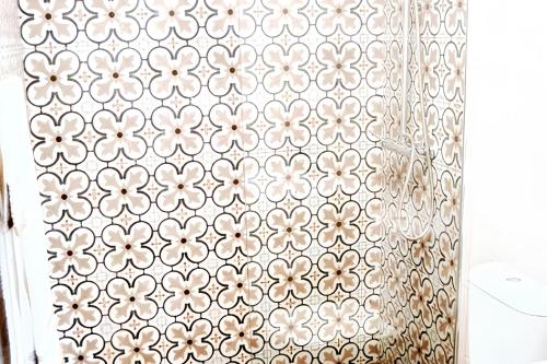 a shower curtain with a floral pattern on it at Charming House in Sistelo + View in Sistelo