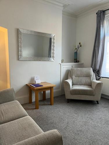 a living room with a couch and a table and a chair at Alston House in Hartlepool