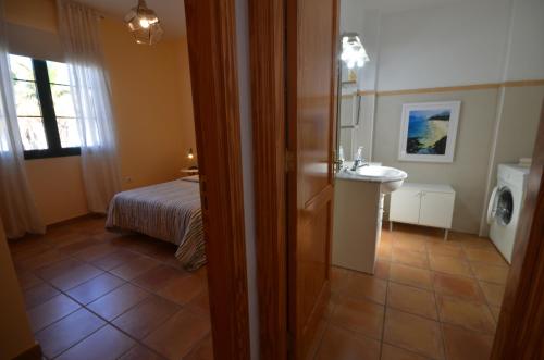 a bathroom with a sink and a bed in a room at Casa Ana Rosa Good location & Close to the beach in Playa Blanca