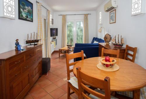 a kitchen and living room with a table and chairs at Casa das Marés by east ALgarve guest in Tavira