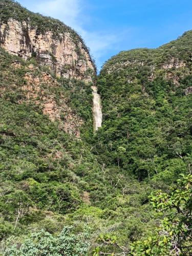 a waterfall on the side of a mountain at Chale1 RabodeGalo in Santana do Riacho