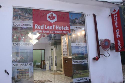 a building with red leaf hotels signs on the wall at Red Leaf Hotels in Chandīgarh