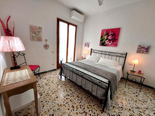 a bedroom with a bed and a table with a lamp at Chianti Best House in Greve in Chianti
