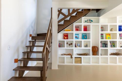 a staircase with a white book shelf next to it at Kitesurfing Paradise, Beautiful Beach House in Taíba