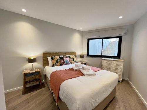 a small bedroom with a bed and a window at Albufeira Stylish 2 With Pool by Homing in Albufeira