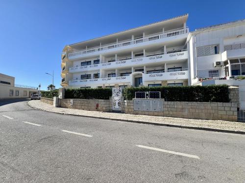 a large white building on the side of a street at Albufeira Stylish 2 With Pool by Homing in Albufeira