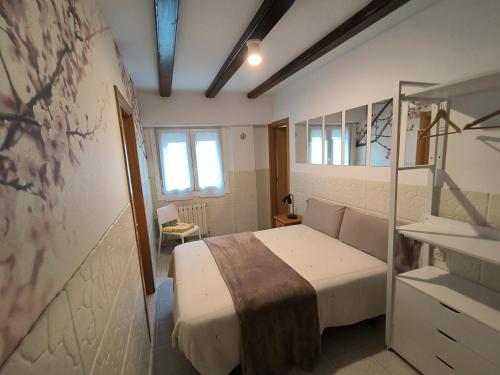 a bedroom with a bed in a room at Agerre Goikoa Agroturismo in Zarautz