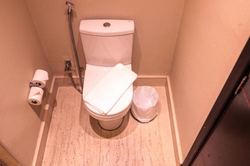 a small bathroom with a toilet and a trash can at Tryp by Wyndham Belo Horizonte Savassi in Belo Horizonte