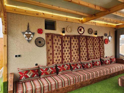 a living room with a couch with red pillows at Tirazir House 2 in Mirleft