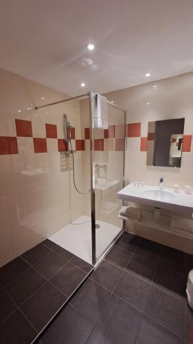 a bathroom with a shower and a sink at Hotel Val Vert in Pouilly-en-Auxois