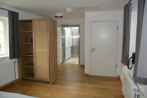 a room with a closet and a door and a hallway at Schloss Thurnau in Thurnau