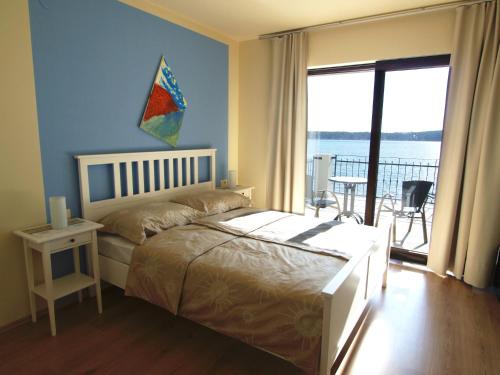a bedroom with a bed and a view of the ocean at Guest House Villa Papalina in Rab