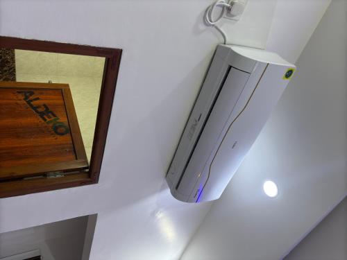 a video game system hanging on a wall next to a mirror at Hotel Ramay Palace in Ayodhya