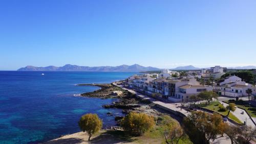 a view of a town on the water at Mar y Paz by Youroom in Can Picafort