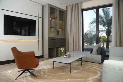 a living room with a couch and a table at Ray Hotel in Kuwait