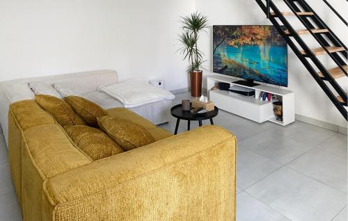 a living room with a couch and a flat screen tv at Jolie Maison in Pornic