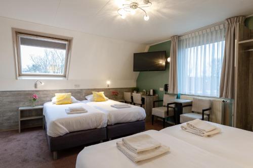 Postel nebo postele na pokoji v ubytování Hotel de Magneet