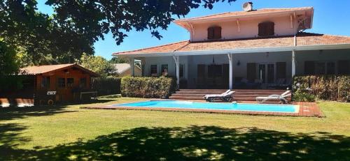 a house with a swimming pool in front of it at Villa Romance in Audenge