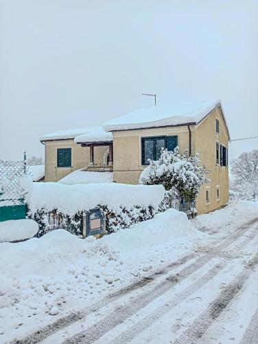 a house covered in snow in front of a house at #914 Home - Irpinia in Nusco
