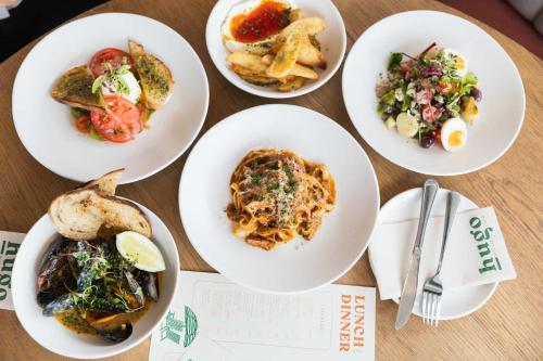 a group of plates of food on a table at Latitude Aparthotel by Totalstay in Cape Town