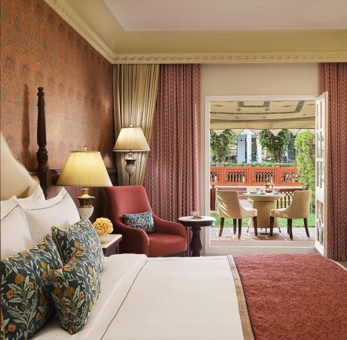 a hotel room with a bed and a patio at Jai Mahal Palace in Jaipur