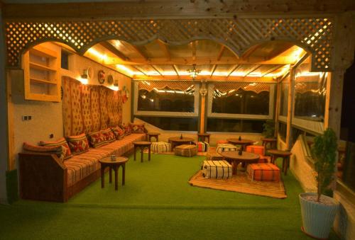 a living room with a couch and chairs and a table at Tirazir House 2 in Mirleft