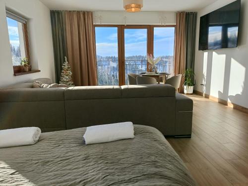 Ένα ή περισσότερα κρεβάτια σε δωμάτιο στο Apartament Dwa Słońca