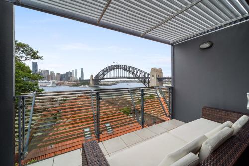 a balcony with a view of the sydney harbour bridge at Breathtaking Sydney Harbour view condo in Sydney