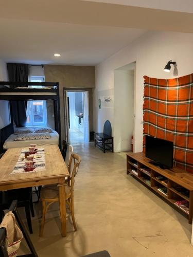 a room with a table and a bed and a bedroom at Transylvania Apartment old town in Bucharest