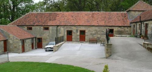 a house with a car parked in front of it at Bed & Breakfast at Newton House Farm in Sneaton