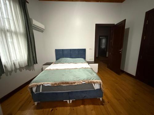 a bedroom with a blue bed in a room at Grand Bedir in Istanbul