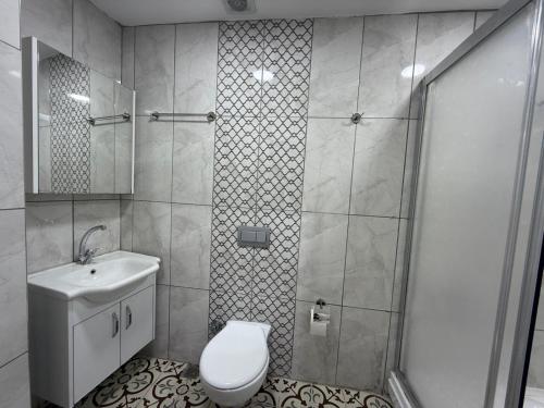 a bathroom with a shower and a toilet and a sink at Grand Bedir in Istanbul