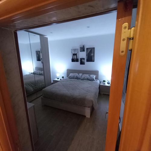 a bedroom with a bed and a large mirror at rismondi 37 in Bari