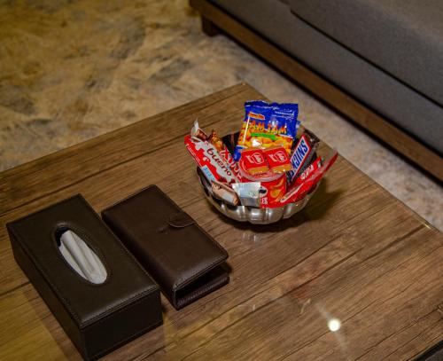 a table with a bowl of candy on top of it at شقق حديقة الروابي إين in Jeddah