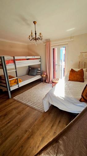 a bedroom with two bunk beds and a chandelier at Splendide T2 Piana in Piana
