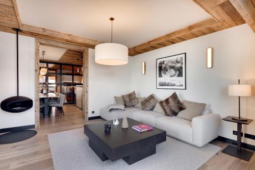un soggiorno con un divano e un tavolo di Antarès NAOS 102 - luxury apartment ski inski out a Méribel
