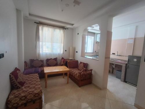 a living room with a couch and a table and chairs at Future in Taghazout