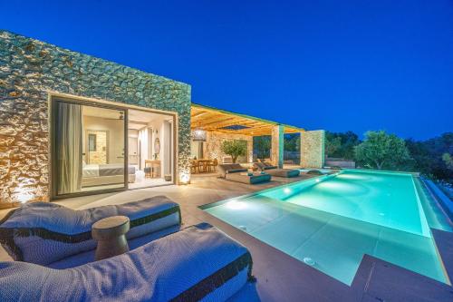 a house with a swimming pool in a yard at Lithos Art Villas in Sarlata