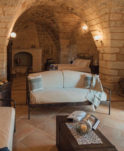 a living room with a couch and a table at Tenuta Masseria & Spa Chicco Rizzo in Sternatia