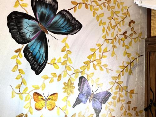 a group of butterflies on a white curtain at Tequendama Hotel Campestre Villavicencio in Villavicencio
